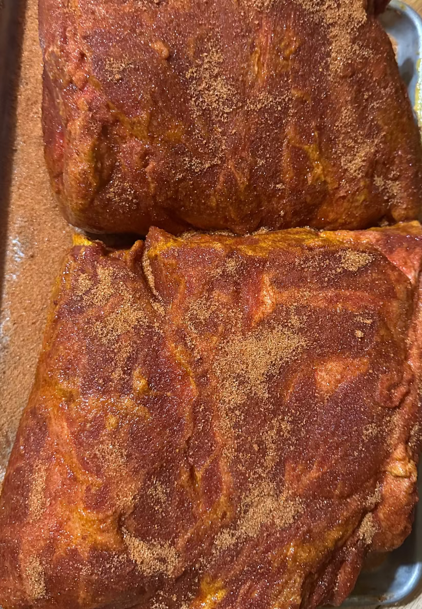 Close-up of seasoned meat on a cutting board